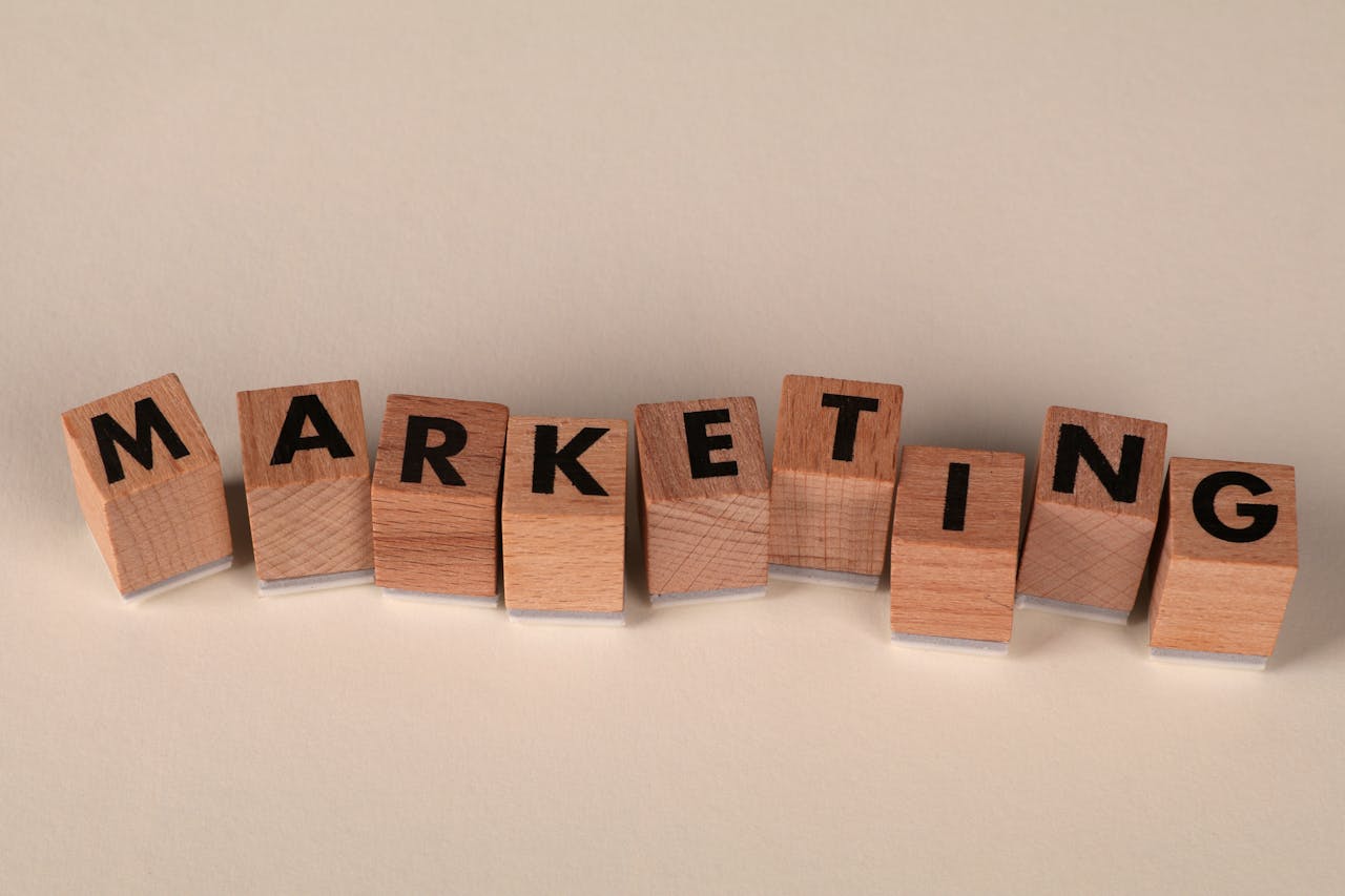 Wooden blocks with letters spelling marketing, ideal for business and advertising visuals.